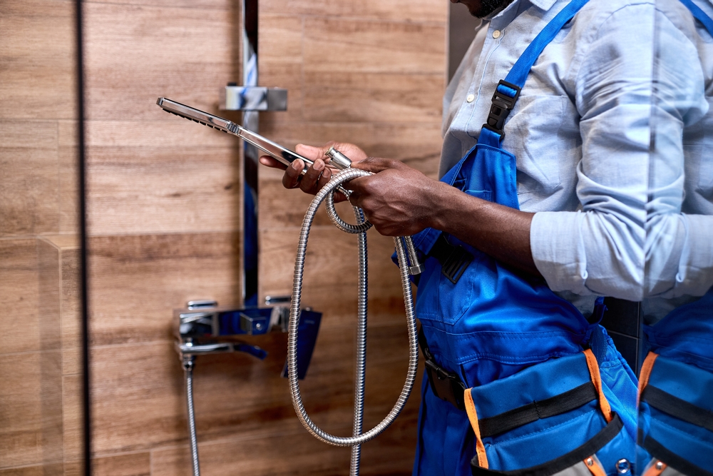 Side,View,On,Black,Repairman,Handyman,In,Blue,Overalls,Holding